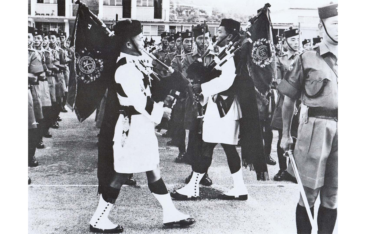 Trooping of the Royal Pipe Banners of both Battalions at the Amalgamation parade in 1969. Pipe Majors 21134550 WO2 Lil Bahadur Gurung 2nd Bn and 21150579 Cpl Bom Bahadur Guring 1st Bn