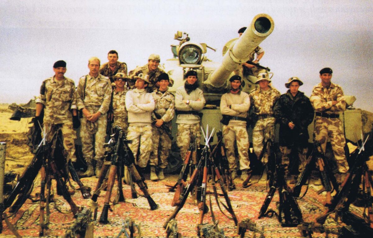 Captain INA Thomas (4th from right) with Major ARD Shirreff and B Squadron 14th/20th Hussars with the war trophies, Iraq 1991.